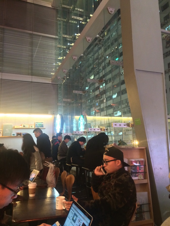The modernist glass face of Starbucks on Nathan road made Kowloon look like a 'behind the glass' museum display