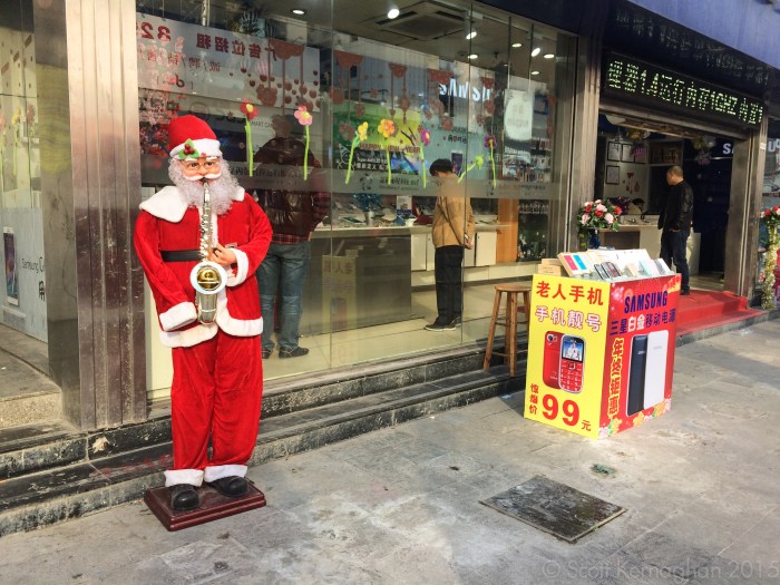 Because nothing says 'fake Samsung shop full of cloned Samsung products' like a one-armed sax playing Santa.